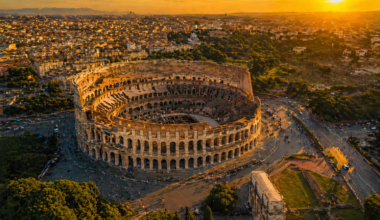 Best place to visit in Italy for the first time — aerial view of Rome Colosseum at golden hour