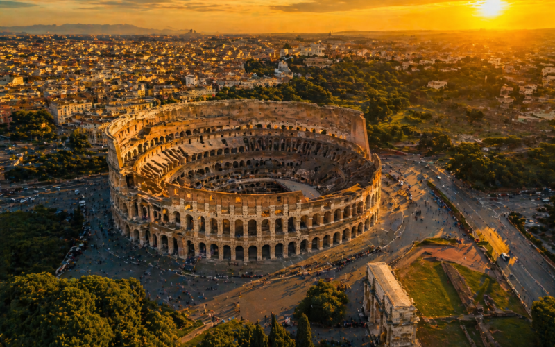 Best place to visit in Italy for the first time — aerial view of Rome Colosseum at golden hour